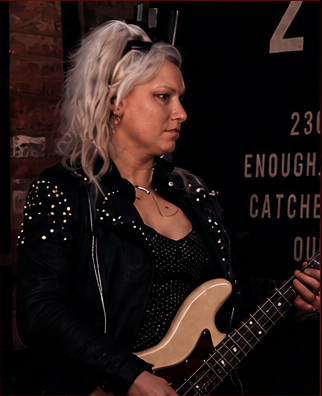 Lisa playing bass on stage